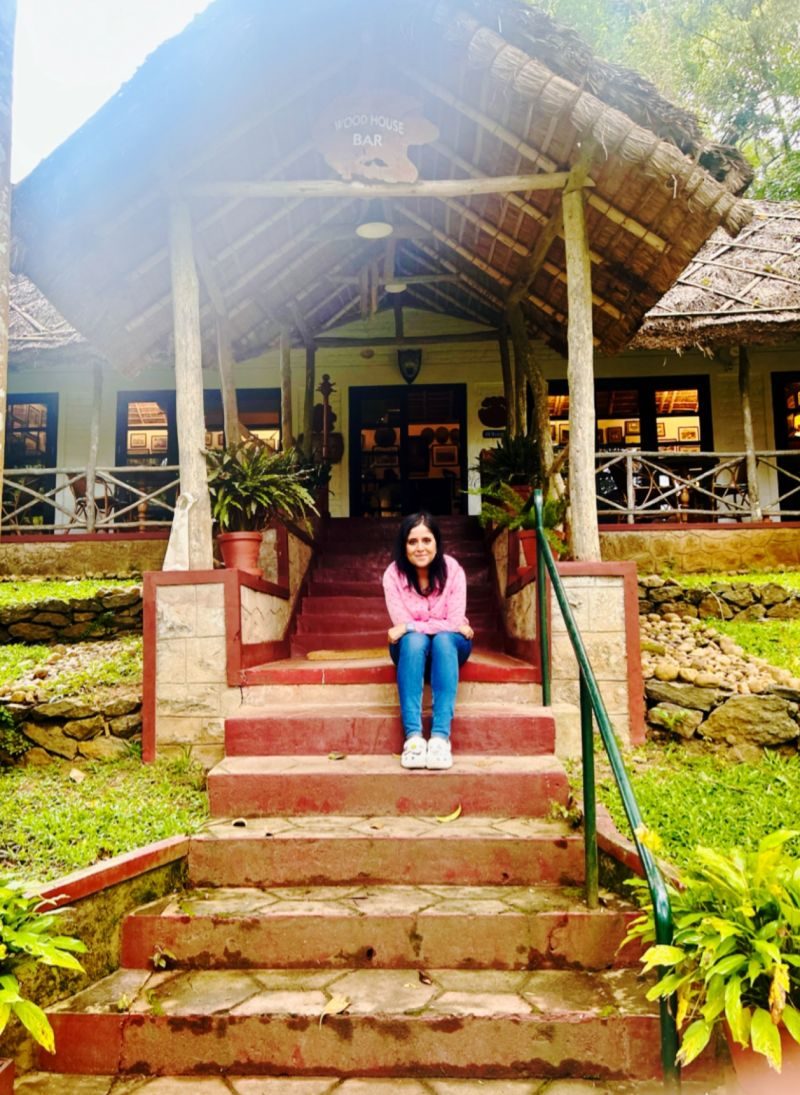 Gunjan Sinha smiling, seated outside