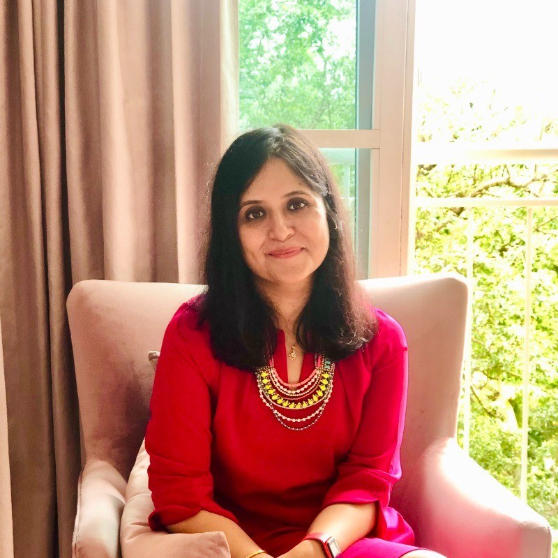 Gunjan Sinha, Executive and Life Coach, seated by a window